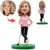 Bobblehead de golf féminine heureuse en chemise rose